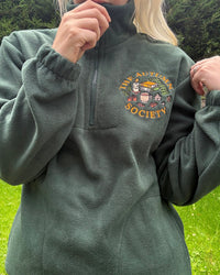 Forest green embroidered quarter zip fleece featuring The Autumn Society autumn design with books, candle, mug and autumn leaves on the chest.