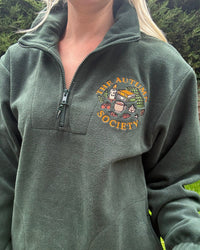 Forest green embroidered quarter zip fleece featuring The Autumn Society autumn design with books, candle, mug and autumn leaves on the chest.